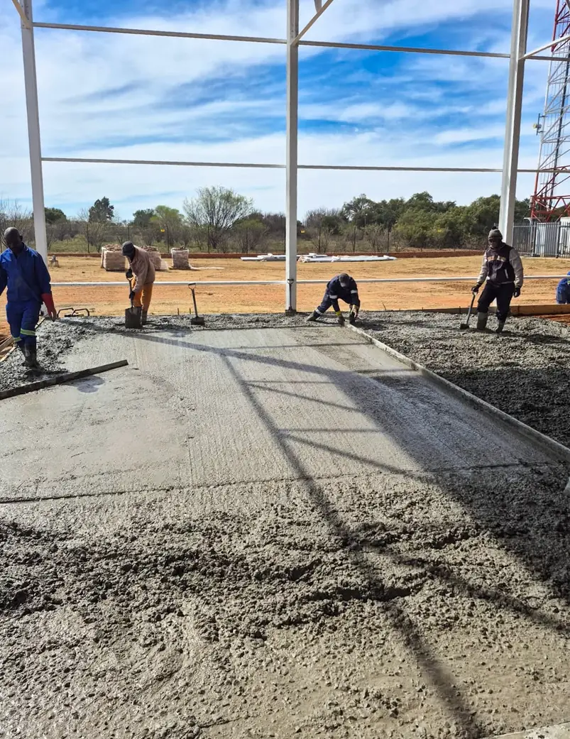 Concrete crew placing and finishing a new slab