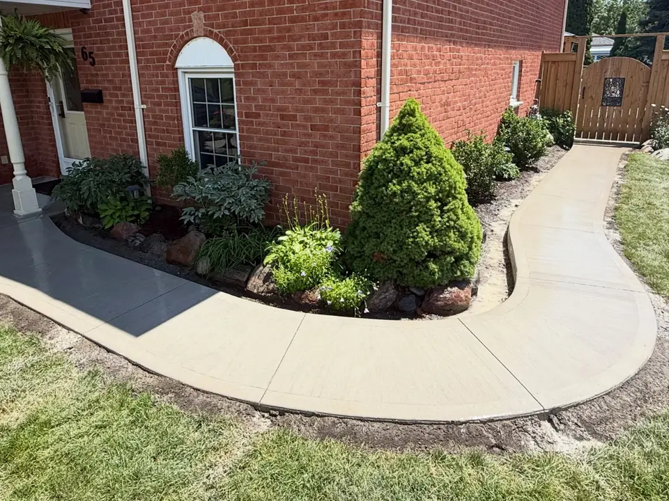Curved concrete front walkway along a planting bed, photo 1 of 6