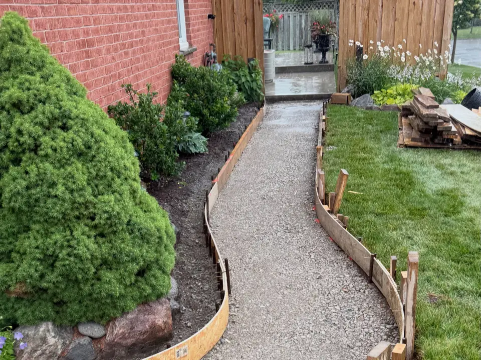 Curved concrete front walkway along a planting bed, photo 3 of 6