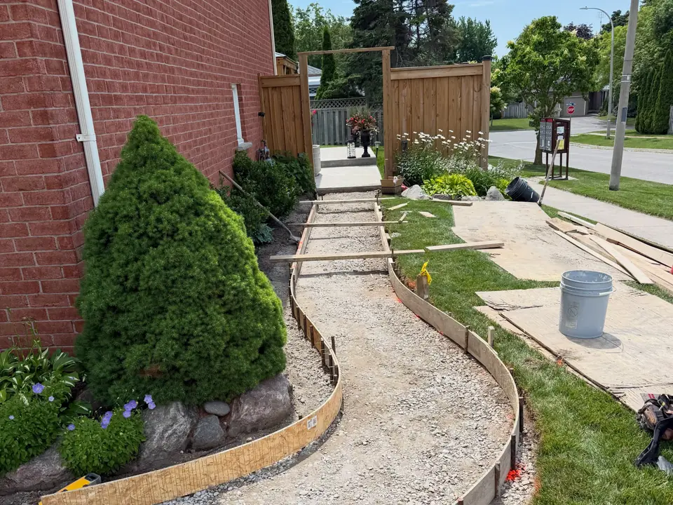 Curved concrete front walkway along a planting bed, photo 5 of 6