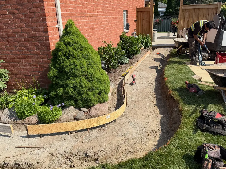 Curved concrete front walkway along a planting bed, photo 6 of 6
