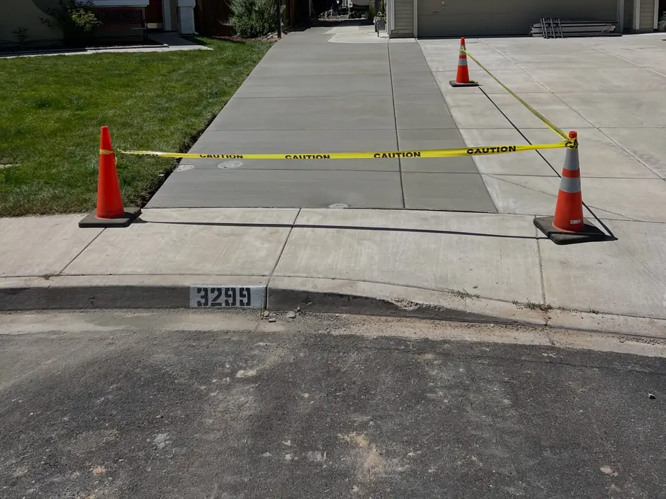 Concrete driveway with a narrow side-yard path along a house
