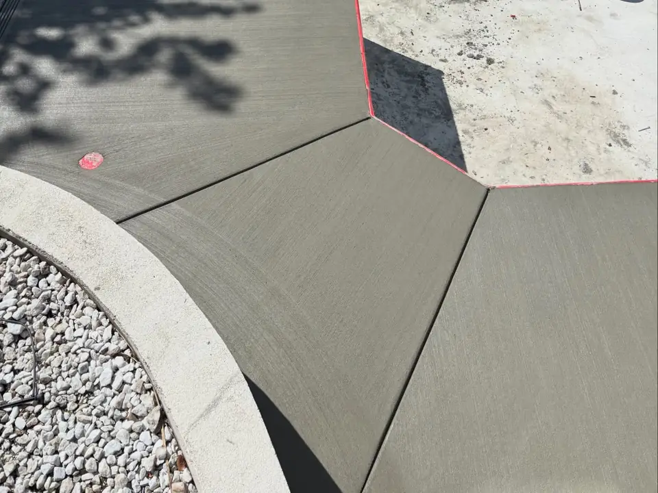 Broom-finished concrete deck and steps around a pool under construction, photo 3 of 10