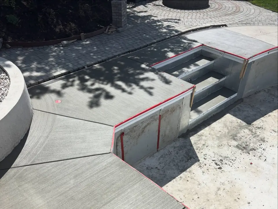 Broom-finished concrete deck and steps around a pool under construction, photo 4 of 10