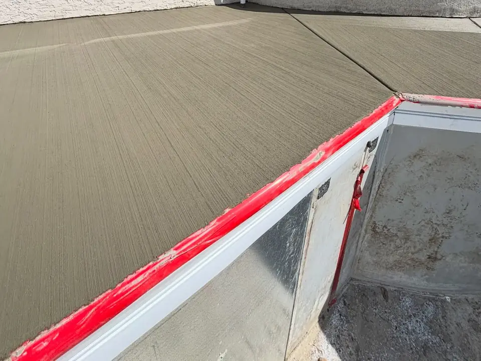 Broom-finished concrete deck and steps around a pool under construction, photo 6 of 10