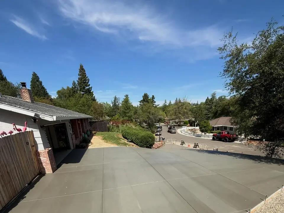 Curved concrete driveway on a sloped residential lot