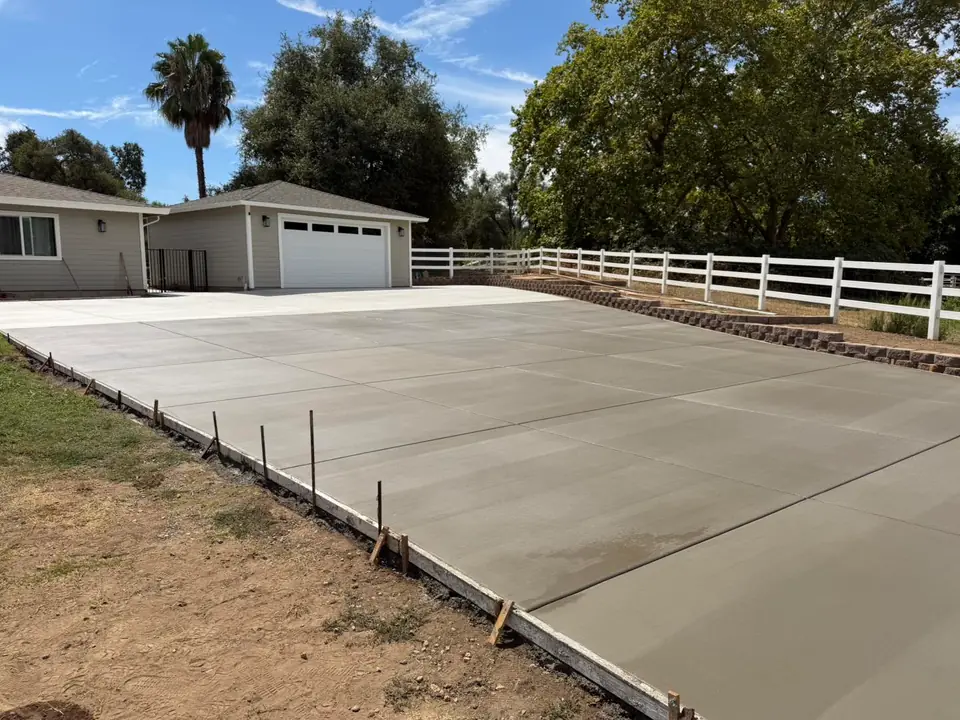 Wide concrete driveway approach to a residential garage
